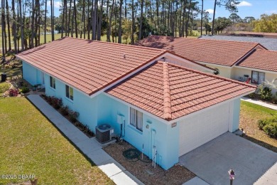 This golf community Florida Home is located on the 11th fairway on The Grand Club - Pine Lakes Course in Florida - for sale on GolfHomes.com, golf home, golf lot