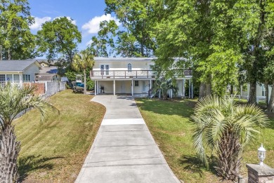 Nestled in the heart of Cherry Grove Beach, this charming home on Surf Golf and Beach Club in South Carolina - for sale on GolfHomes.com, golf home, golf lot