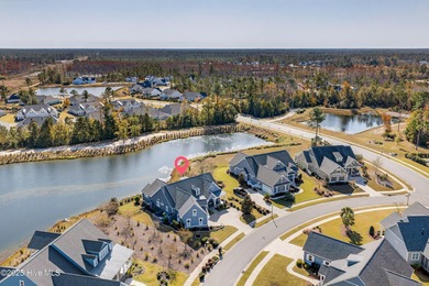 Exquisite home with a view of the pond located in the on Cape Fear National At Brunswick Forest in North Carolina - for sale on GolfHomes.com, golf home, golf lot