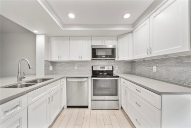 Enjoy ultimate convenience in this beautifully remodeled on Cove Cay Country Club in Florida - for sale on GolfHomes.com, golf home, golf lot
