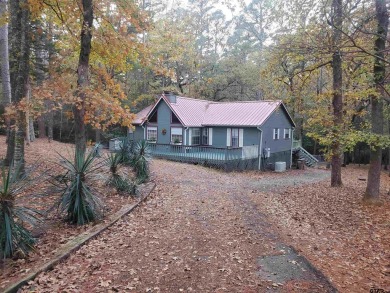 Beautiful chalet style home with Personality plus nestled on two on Holly Lake Ranch Golf Club in Texas - for sale on GolfHomes.com, golf home, golf lot