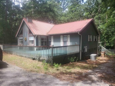 Beautiful chalet style home with Personality plus nestled on two on Holly Lake Ranch Golf Club in Texas - for sale on GolfHomes.com, golf home, golf lot