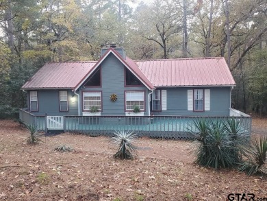 Beautiful chalet style home with Personality plus nestled on two on Holly Lake Ranch Golf Club in Texas - for sale on GolfHomes.com, golf home, golf lot