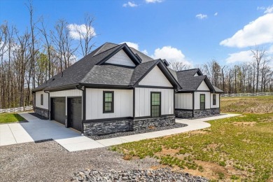 Nestled within the verdant embrace of Tennessee's picturesque on Sweetens Cove Golf Club in Tennessee - for sale on GolfHomes.com, golf home, golf lot