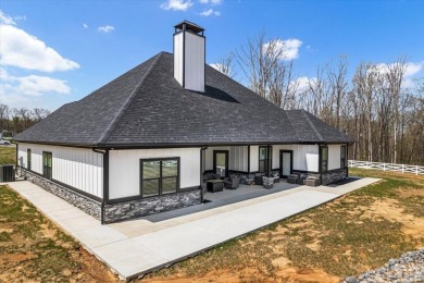 Nestled within the verdant embrace of Tennessee's picturesque on Sweetens Cove Golf Club in Tennessee - for sale on GolfHomes.com, golf home, golf lot