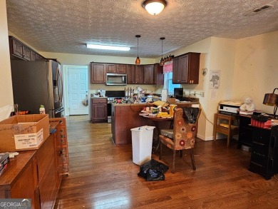 This 3 bed, 2 bath single-story home sits on the smaller fishing on Fairfield Plantation Golf and Country Club in Georgia - for sale on GolfHomes.com, golf home, golf lot