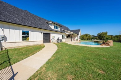 This beautifully designed home offers a private entrance to the on Cedar Creek Country Club in Texas - for sale on GolfHomes.com, golf home, golf lot