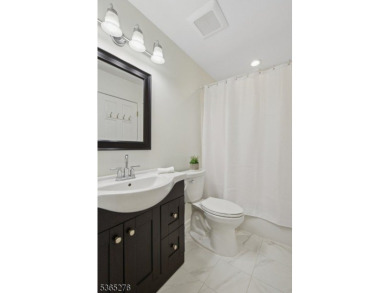 Experience elevated living in this sun-drenched, end-unit on Echo Lake Country Club in New Jersey - for sale on GolfHomes.com, golf home, golf lot