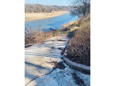 Beautiful, buildable riverfront lot with concrete path access to on Pecan Plantation Country Club in Texas - for sale on GolfHomes.com, golf home, golf lot
