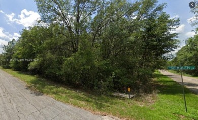 This beautiful corner lot enjoys convenient access to a golf on Citrus Springs Country Club in Florida - for sale on GolfHomes.com, golf home, golf lot