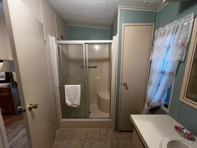 Welcome to this well-maintained 2-bedroom, 2-bath home offering on Lake Henry Golf Club in Florida - for sale on GolfHomes.com, golf home, golf lot
