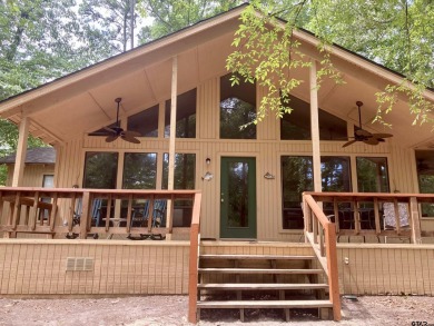 Situated on a hill, this one owner, two lot home allows for the on Holly Lake Ranch Golf Club in Texas - for sale on GolfHomes.com, golf home, golf lot