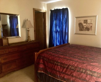 Situated on a hill, this one owner, two lot home allows for the on Holly Lake Ranch Golf Club in Texas - for sale on GolfHomes.com, golf home, golf lot