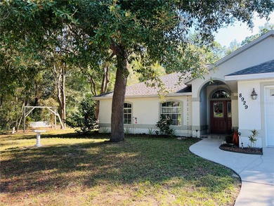 Charming three-bedroom, two-bathroom home featuring a two-car on Citrus Springs Country Club in Florida - for sale on GolfHomes.com, golf home, golf lot