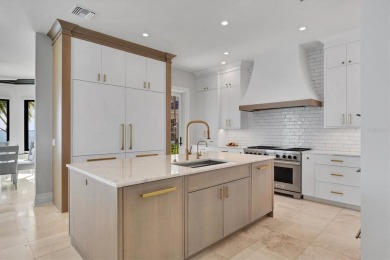 A luxurious coastal retreat at the water's edge on Longboat Key on Links on Longboat Golf Club in Florida - for sale on GolfHomes.com, golf home, golf lot