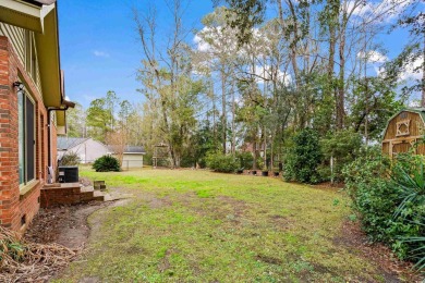 Check out this beautifully landscaped brick and wood exterior on Wedgefield Plantation Golf Club in South Carolina - for sale on GolfHomes.com, golf home, golf lot