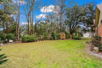 Check out this beautifully landscaped brick and wood exterior on Wedgefield Plantation Golf Club in South Carolina - for sale on GolfHomes.com, golf home, golf lot