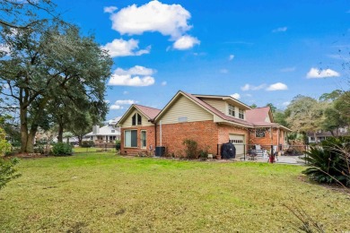 Check out this beautifully landscaped brick and wood exterior on Wedgefield Plantation Golf Club in South Carolina - for sale on GolfHomes.com, golf home, golf lot