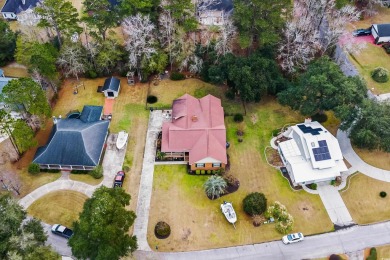 Check out this beautifully landscaped brick and wood exterior on Wedgefield Plantation Golf Club in South Carolina - for sale on GolfHomes.com, golf home, golf lot