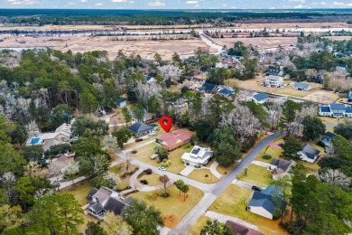 Check out this beautifully landscaped brick and wood exterior on Wedgefield Plantation Golf Club in South Carolina - for sale on GolfHomes.com, golf home, golf lot