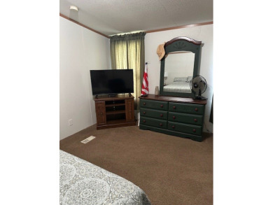 Location! Location! This Waterview 3B/2B MH is walk in ready & on Cypress Bend Golf Course in Texas - for sale on GolfHomes.com, golf home, golf lot