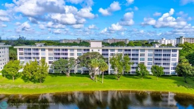 Enjoy serene water views of the lake and fountain as soon as you on Palm-Aire Country Club and Resort - Palms in Florida - for sale on GolfHomes.com, golf home, golf lot