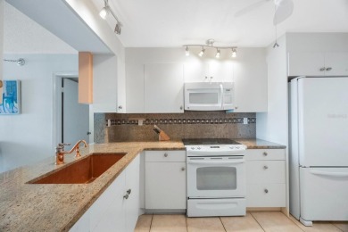 Experience Waterfront Living in this Charming 2-Bed, 2-Bath on Isla Del Sol Yacht and Country Club in Florida - for sale on GolfHomes.com, golf home, golf lot