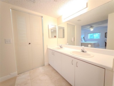 Spacious, sunlit 2-bed, 2-bath corner condo in the sought-after on Flamingo Lakes Country Club in Florida - for sale on GolfHomes.com, golf home, golf lot
