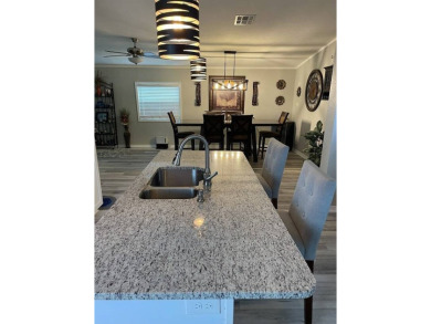 Location with stunning views of the golf course and waterpletely on Del Tura Golf and Country Club in Florida - for sale on GolfHomes.com, golf home, golf lot