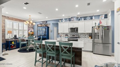 This beautifully appointed DREAMSICLE sits on a unique lot with on LPGA International Golf Course in Florida - for sale on GolfHomes.com, golf home, golf lot