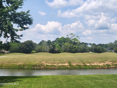 Expansive open views of Lions Paw #13 fairway and pond from this on Ocean Ridge Plantation in North Carolina - for sale on GolfHomes.com, golf home, golf lot