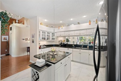 Welcome to this charming 3-bedroom, 2-bathroom WATERFRONT home on East Lake Woodlands Country Club in Florida - for sale on GolfHomes.com, golf home, golf lot
