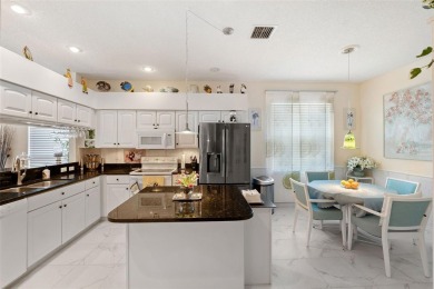 Welcome to this charming 3-bedroom, 2-bathroom WATERFRONT home on East Lake Woodlands Country Club in Florida - for sale on GolfHomes.com, golf home, golf lot