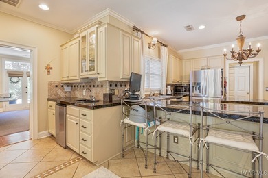 Nestled among mature trees and overlooking Wynlakes Golf Course on Wynlakes Golf and Country Club in Alabama - for sale on GolfHomes.com, golf home, golf lot