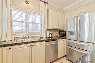 Nestled among mature trees and overlooking Wynlakes Golf Course on Wynlakes Golf and Country Club in Alabama - for sale on GolfHomes.com, golf home, golf lot