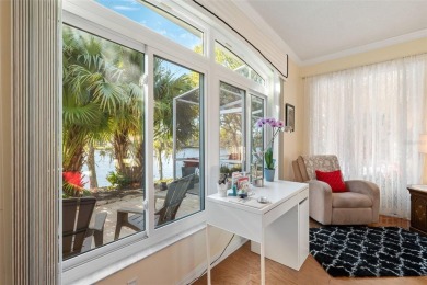 Welcome to this charming 3-bedroom, 2-bathroom WATERFRONT home on East Lake Woodlands Country Club in Florida - for sale on GolfHomes.com, golf home, golf lot