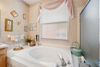 Welcome to this charming 3-bedroom, 2-bathroom WATERFRONT home on East Lake Woodlands Country Club in Florida - for sale on GolfHomes.com, golf home, golf lot
