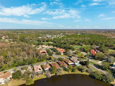 Welcome to this charming 3-bedroom, 2-bathroom WATERFRONT home on East Lake Woodlands Country Club in Florida - for sale on GolfHomes.com, golf home, golf lot
