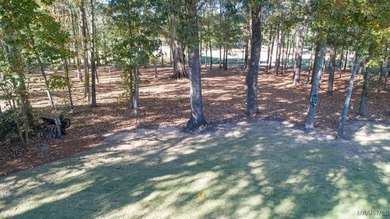 Nestled among mature trees and overlooking Wynlakes Golf Course on Wynlakes Golf and Country Club in Alabama - for sale on GolfHomes.com, golf home, golf lot