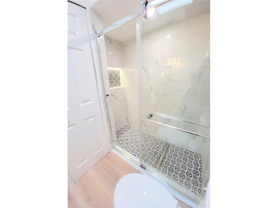 Fully updated 2-bedroom, 2-bath residence on Club House Drive on Palm Harbor Golf Club in Florida - for sale on GolfHomes.com, golf home, golf lot