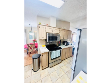 This charming two-bedroom, two-bathroom home is nestled in a on Pine Lakes Country Club in Florida - for sale on GolfHomes.com, golf home, golf lot
