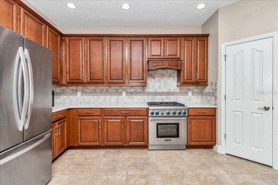 This thoughtfully expanded Jacaranda model offers 4 bedrooms, 3 on Summerglen Country Club in Florida - for sale on GolfHomes.com, golf home, golf lot