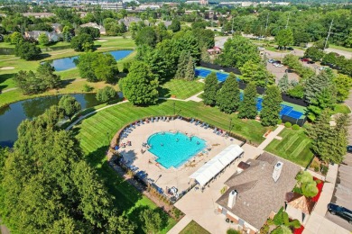 Stunning golf course, pond, and bridge views surround this on Bushwood Golf Club in Michigan - for sale on GolfHomes.com, golf home, golf lot