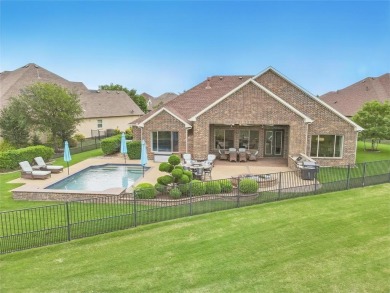 Situated directly on the 5th green, this luxury residence offers on Wildhorse Golf Club of Robson Ranch in Texas - for sale on GolfHomes.com, golf home, golf lot