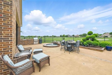 Situated directly on the 5th green, this luxury residence offers on Wildhorse Golf Club of Robson Ranch in Texas - for sale on GolfHomes.com, golf home, golf lot