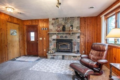 Nestled in the gated community of Lost Lake Woods Club in on Lost Lake Woods Club in Michigan - for sale on GolfHomes.com, golf home, golf lot