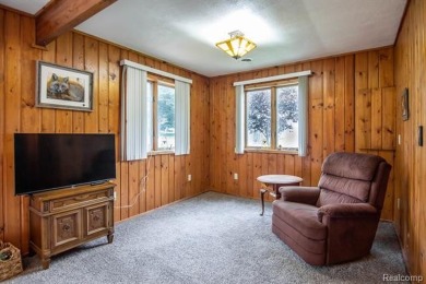 Nestled in the gated community of Lost Lake Woods Club in on Lost Lake Woods Club in Michigan - for sale on GolfHomes.com, golf home, golf lot