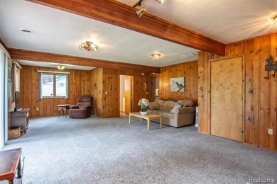 Nestled in the gated community of Lost Lake Woods Club in on Lost Lake Woods Club in Michigan - for sale on GolfHomes.com, golf home, golf lot