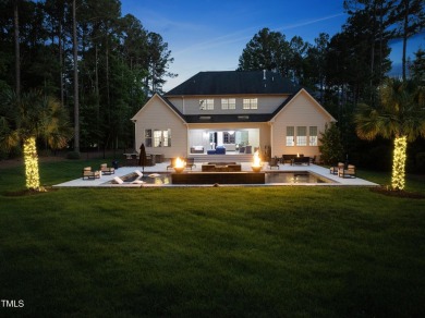 Experience luxury and lifestyle in this exceptional 5-bedroom, 5 on Hasentree Club in North Carolina - for sale on GolfHomes.com, golf home, golf lot