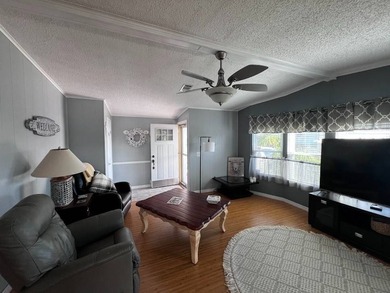 Beautifully maintained 2-bedroom, 2-bath home offering comfort on Lake Henry Golf Club in Florida - for sale on GolfHomes.com, golf home, golf lot